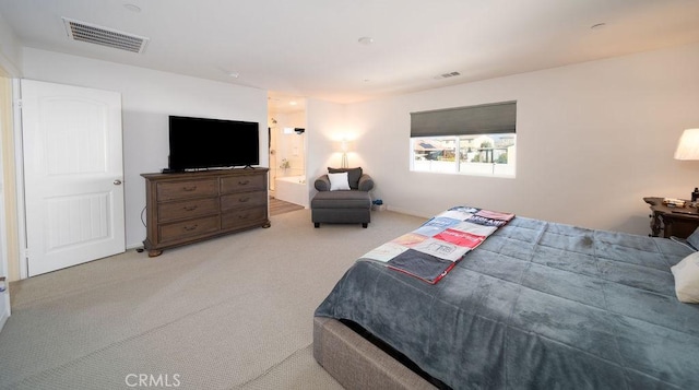 carpeted bedroom with connected bathroom