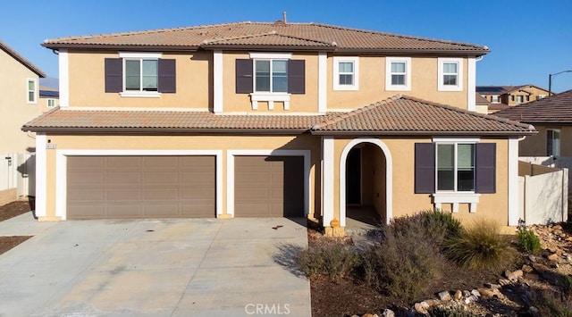 mediterranean / spanish-style house with a garage