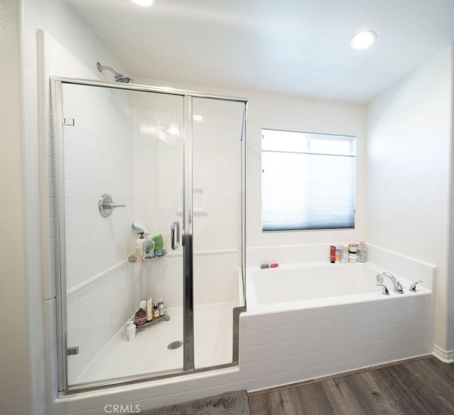 bathroom with shower with separate bathtub and hardwood / wood-style floors