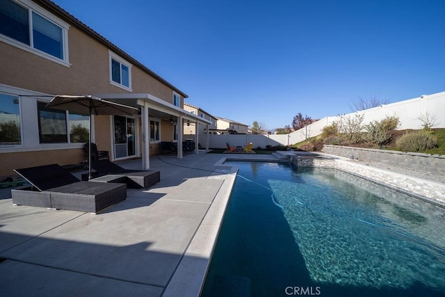 view of swimming pool with a patio