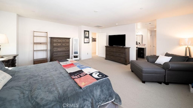 carpeted bedroom with connected bathroom