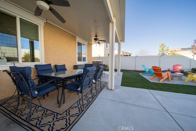 view of patio with ceiling fan and a fire pit