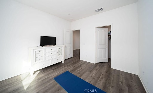 unfurnished bedroom with dark hardwood / wood-style flooring