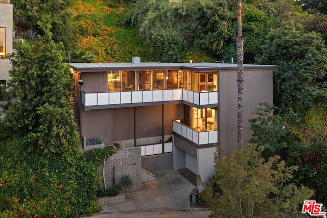 back of property featuring a balcony