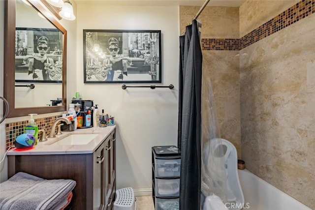 bathroom featuring shower / tub combo with curtain, vanity, and decorative backsplash