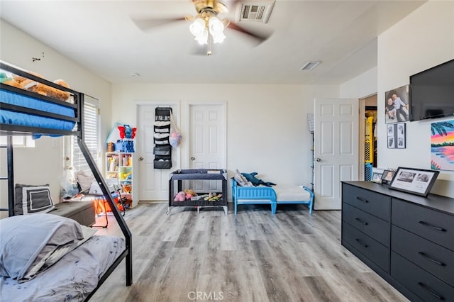 bedroom with ceiling fan and light hardwood / wood-style floors