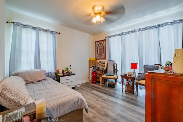 bedroom with hardwood / wood-style floors and ceiling fan