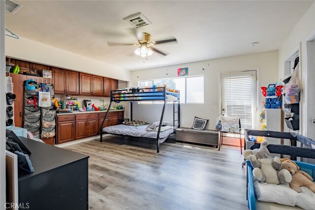 bedroom with light hardwood / wood-style floors and ceiling fan