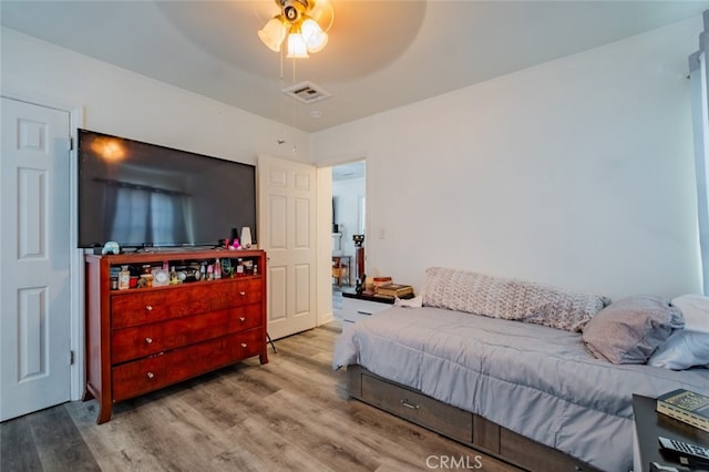 bedroom with hardwood / wood-style flooring and ceiling fan