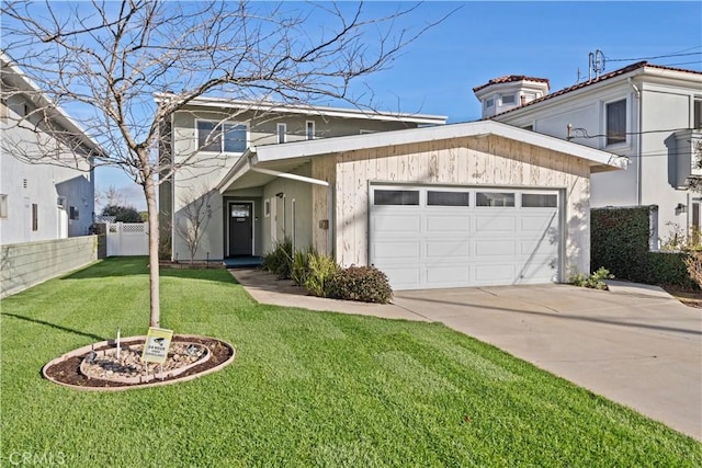 view of front facade with a garage and a front lawn