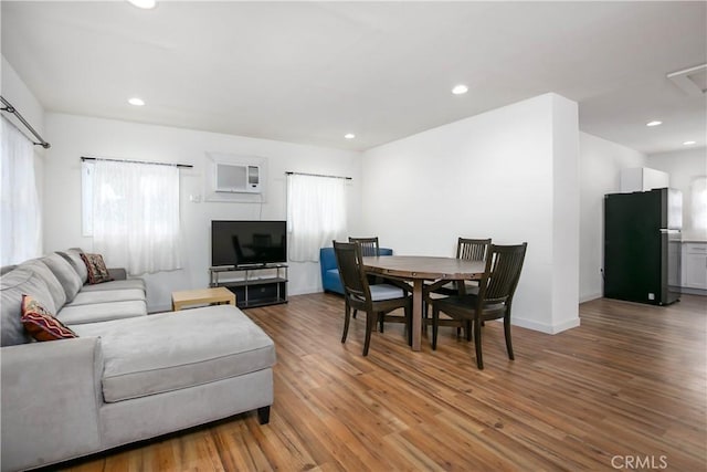 dining space featuring wood-type flooring and plenty of natural light