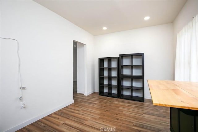 unfurnished office featuring dark wood-type flooring