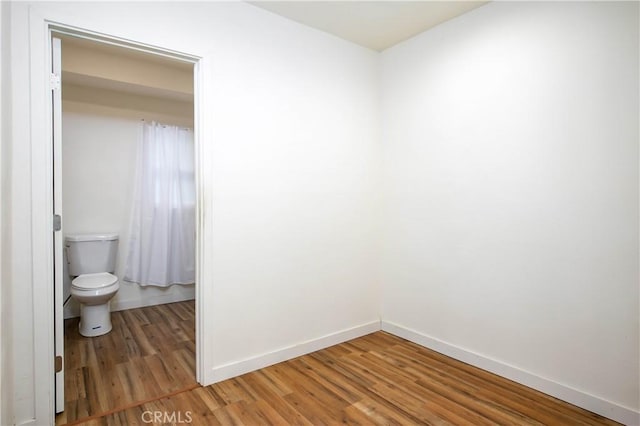 unfurnished room with hardwood / wood-style flooring