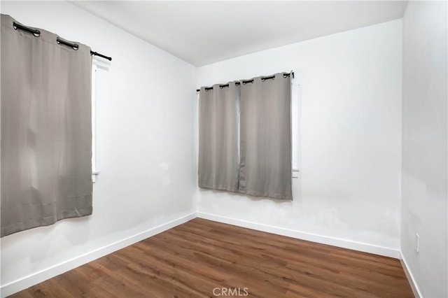 unfurnished room with hardwood / wood-style floors