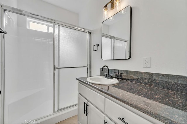 bathroom featuring vanity and a shower with shower door