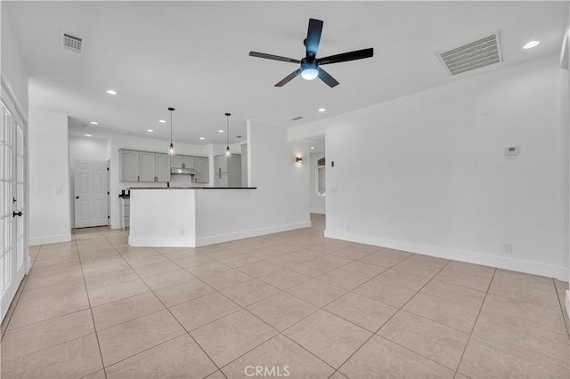 unfurnished living room with light tile patterned floors and ceiling fan