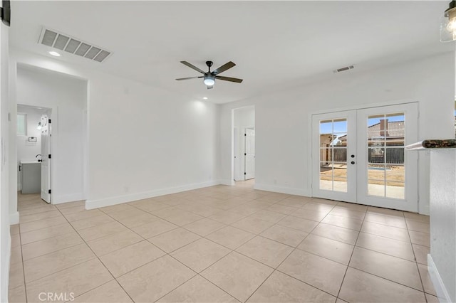 unfurnished room with light tile patterned floors, ceiling fan, and french doors