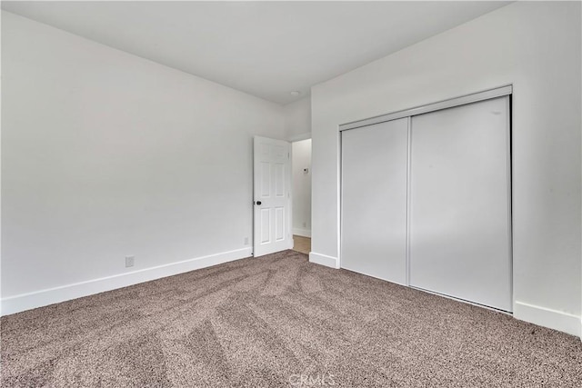 unfurnished bedroom with carpet floors and a closet