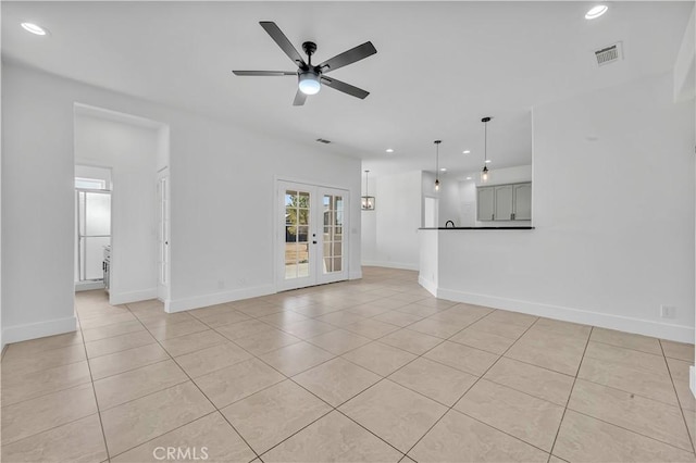 unfurnished living room featuring light tile patterned flooring, ceiling fan, and french doors