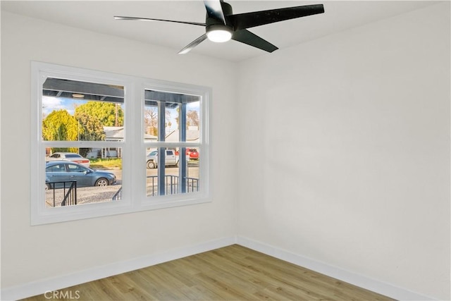 spare room with hardwood / wood-style flooring and ceiling fan