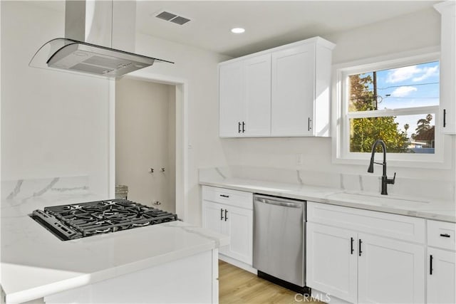 kitchen featuring appliances with stainless steel finishes, sink, and white cabinets