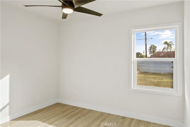 spare room with light hardwood / wood-style flooring and ceiling fan