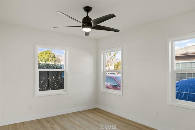 empty room featuring ceiling fan and light hardwood / wood-style floors