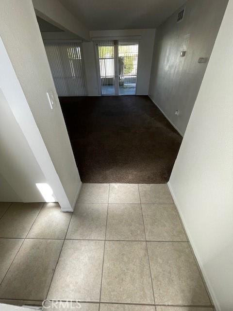 hallway with light tile patterned floors and french doors