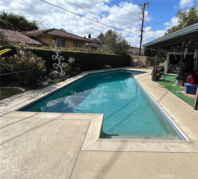 view of swimming pool featuring a patio area, a fenced backyard, and a fenced in pool