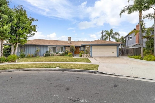 ranch-style house with an attached garage, concrete driveway, and a front yard