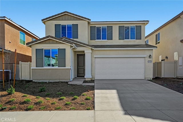 view of front of house featuring fence, concrete driveway, and stucco siding