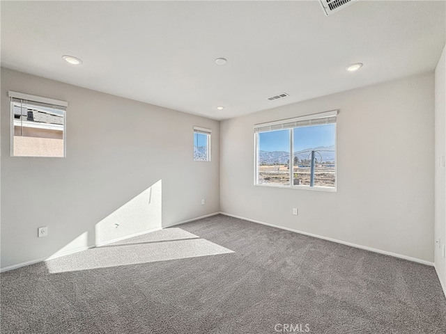 empty room featuring recessed lighting, carpet flooring, and baseboards