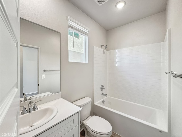 bathroom with washtub / shower combination, vanity, and toilet