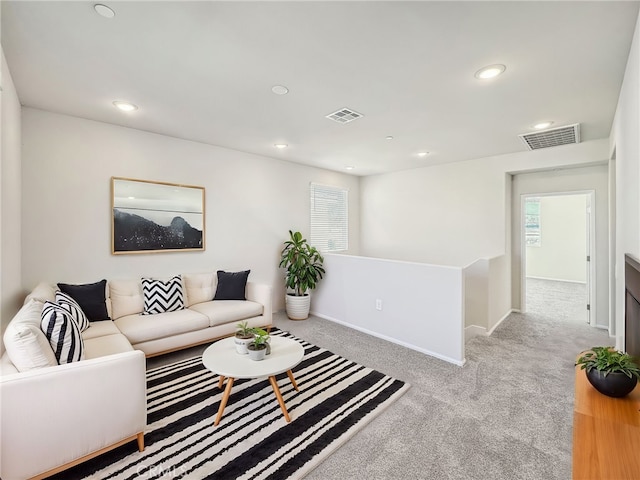 living room with recessed lighting and visible vents