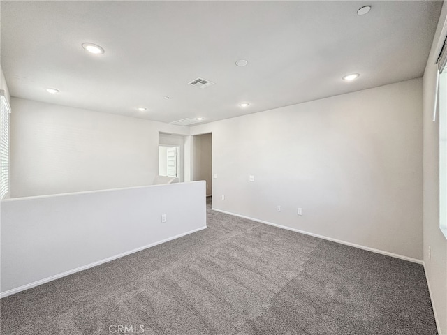 carpeted spare room with baseboards, visible vents, and recessed lighting