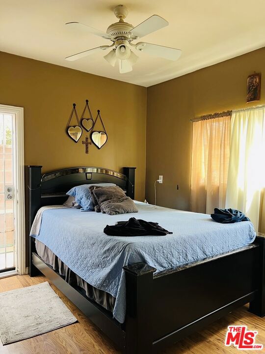 bedroom featuring hardwood / wood-style flooring and ceiling fan