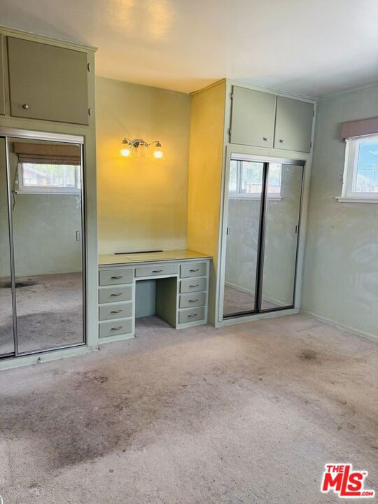 unfurnished bedroom featuring light colored carpet