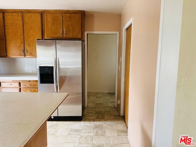 kitchen with tasteful backsplash and stainless steel fridge with ice dispenser