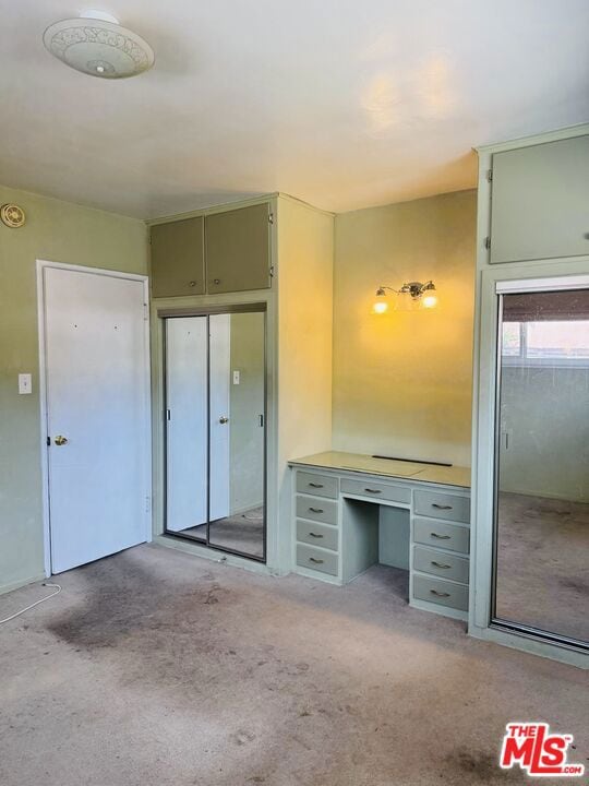 unfurnished bedroom featuring light colored carpet