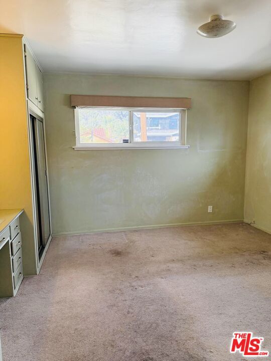 unfurnished room with light colored carpet