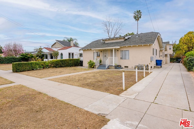 bungalow with a front yard