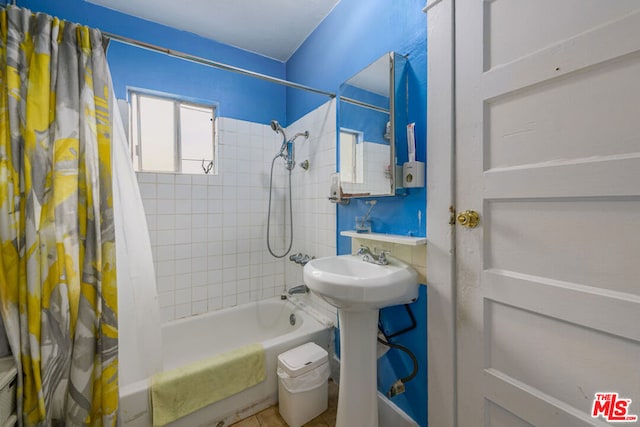 bathroom with shower / tub combo with curtain and sink