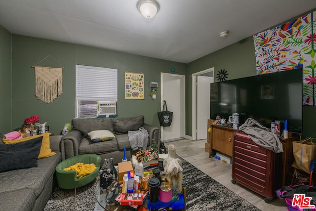 living room with cooling unit and light wood-type flooring