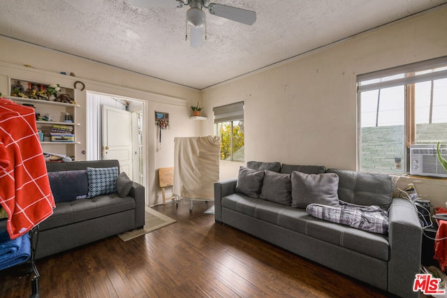 living room with ceiling fan, dark hardwood / wood-style floors, and a textured ceiling