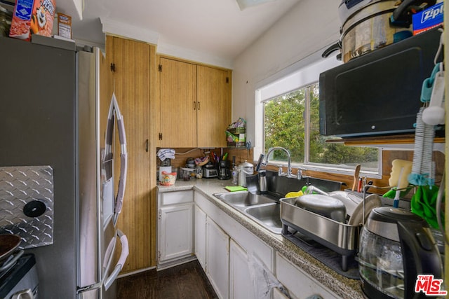 kitchen featuring dark hardwood / wood-style floors, sink, and stainless steel fridge