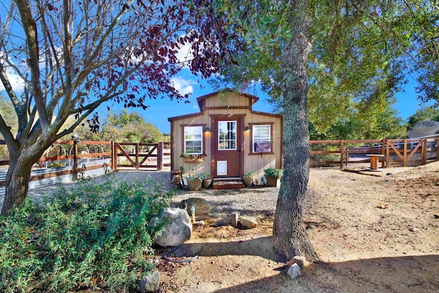 exterior space with an outbuilding, a gate, and fence