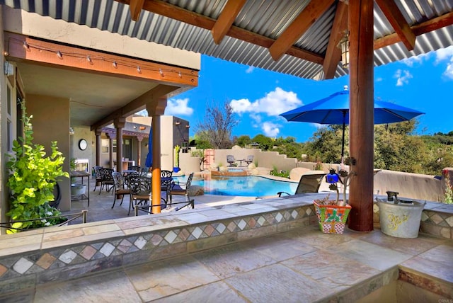 view of patio featuring a fenced in pool and fence