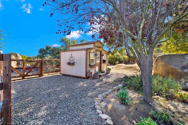 view of shed with fence