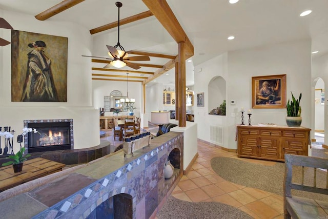 living area featuring beamed ceiling, visible vents, recessed lighting, light tile patterned flooring, and a fireplace