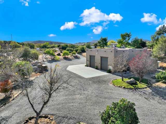 exterior space featuring stucco siding, concrete driveway, and an attached garage